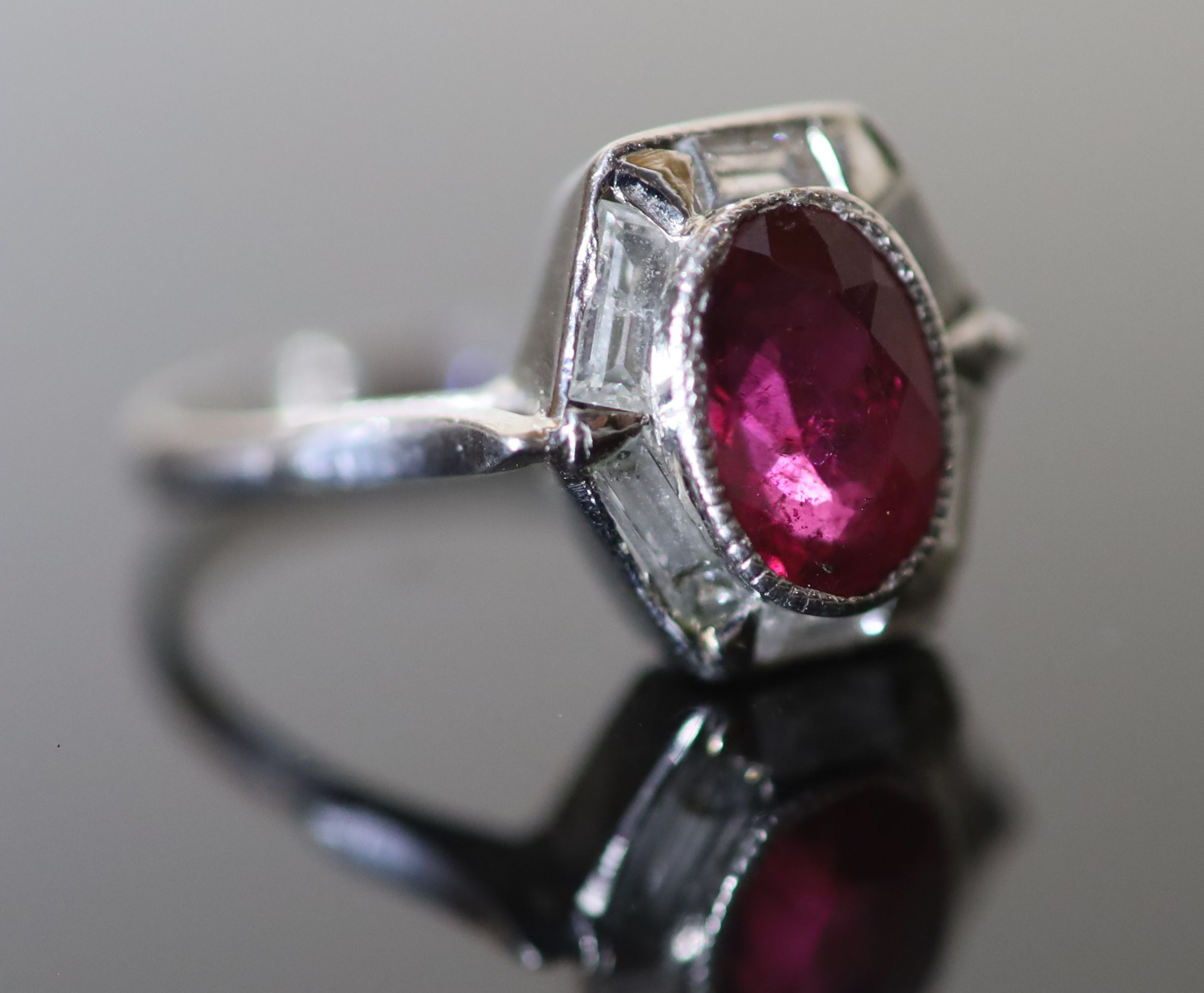 A modern platinum, pinkish/red tourmaline and six stone baguette cut diamond set hexagonal cluster ring,